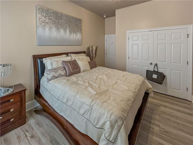 bedroom featuring hardwood / wood-style flooring and a closet