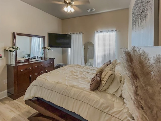 bedroom with light hardwood / wood-style floors and ceiling fan