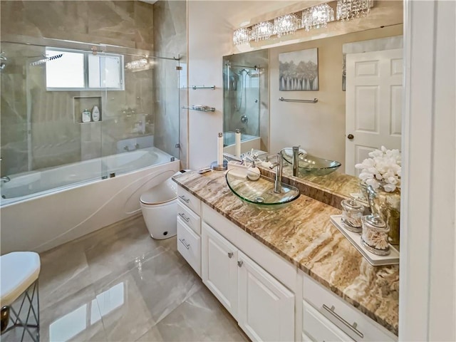 full bathroom featuring vanity, toilet, and bath / shower combo with glass door