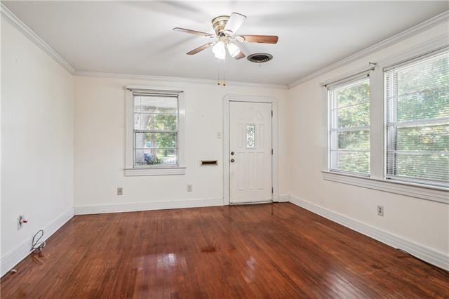 foyer featuring crown molding, plenty of natural light, and dark hardwood / wood-style floors