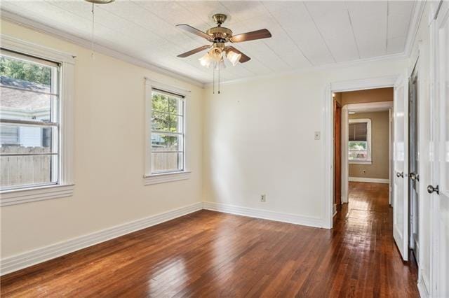 unfurnished room with ornamental molding, ceiling fan, and dark hardwood / wood-style flooring