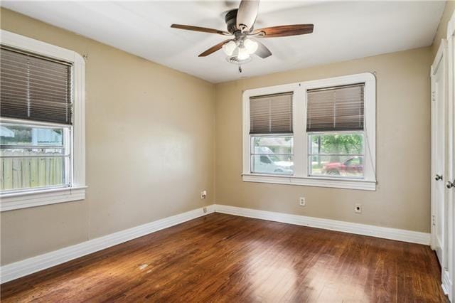 unfurnished room with dark wood-type flooring and ceiling fan