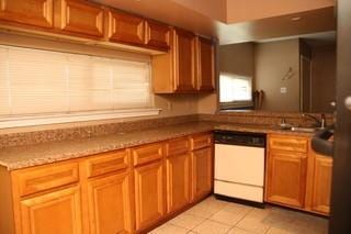 168 Prairieveiw Ct, Avondale, LA 70094 - kitchen with white dishwasher, light tile patterned flooring, brown cabinetry, and a sink