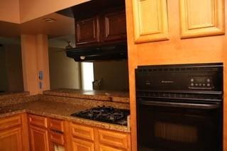 168 Prairieveiw Ct, Avondale, LA 70094 - kitchen with black appliances, under cabinet range hood, and stone counters
