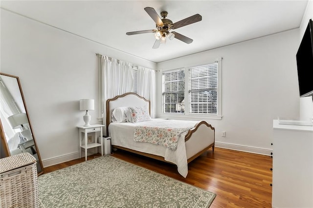 bedroom featuring ceiling fan and dark wood-type flooring