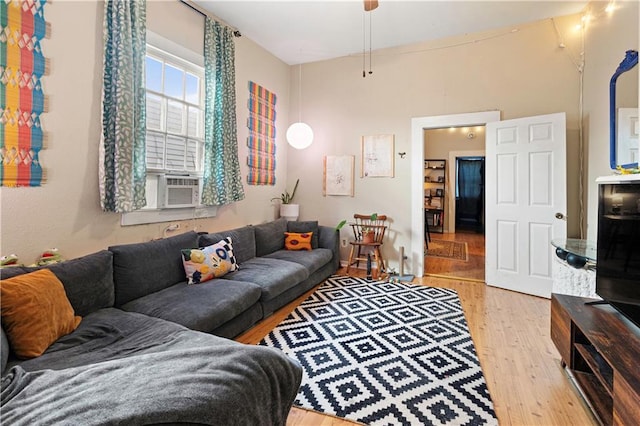 living room with cooling unit and light wood-type flooring