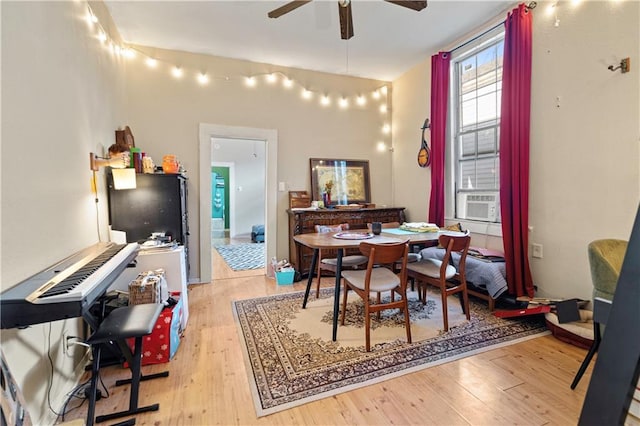 dining room with ceiling fan, light hardwood / wood-style flooring, and cooling unit