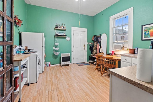 office area featuring heating unit, cooling unit, and light hardwood / wood-style floors