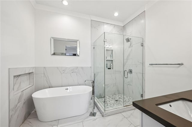 bathroom featuring separate shower and tub, crown molding, and vanity