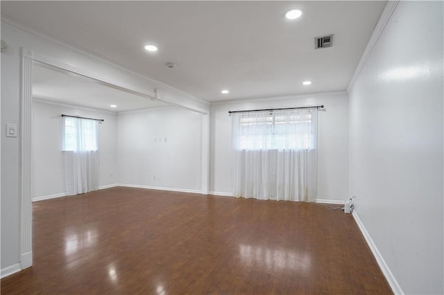 empty room with ornamental molding and dark hardwood / wood-style floors