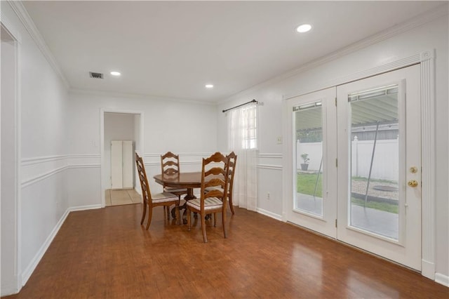 dining room featuring hardwood / wood-style floors and ornamental molding