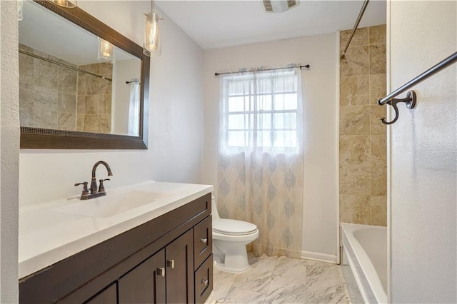 full bathroom featuring tiled shower / bath, vanity, and toilet