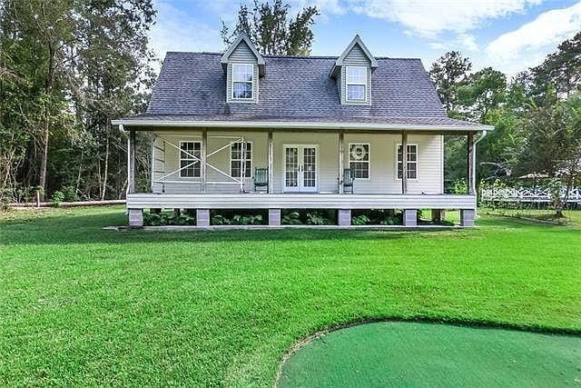 rear view of house with a lawn