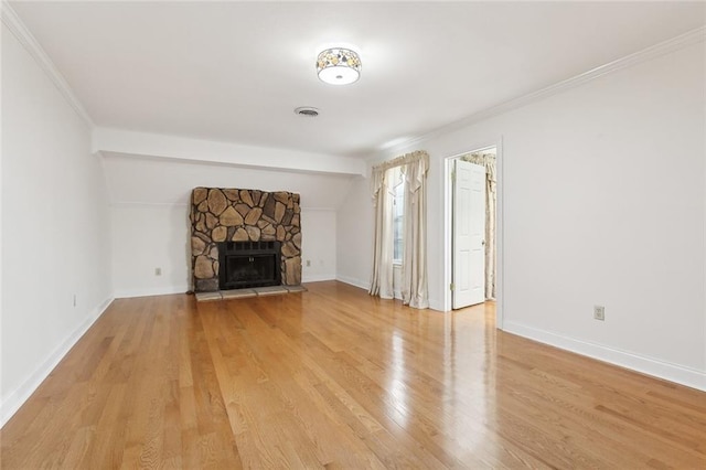 unfurnished living room featuring crown molding, light wood-type flooring, and a fireplace