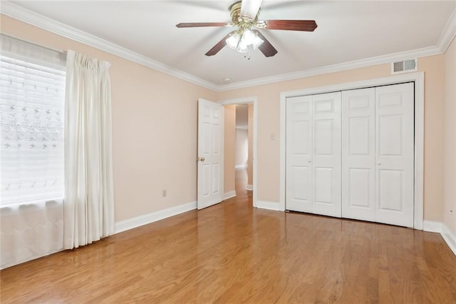 unfurnished bedroom with hardwood / wood-style flooring, ceiling fan, and crown molding