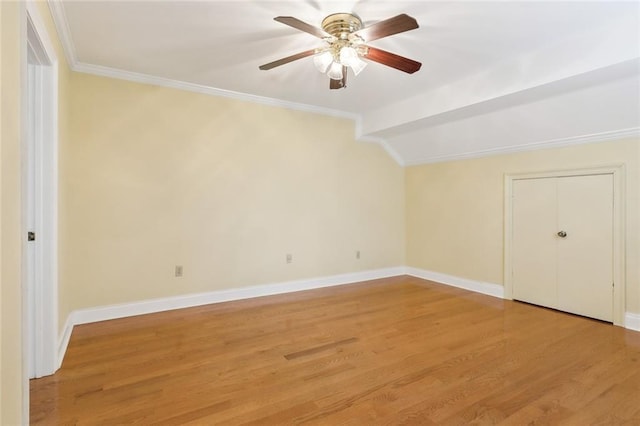 interior space featuring hardwood / wood-style floors, lofted ceiling, ceiling fan, and crown molding