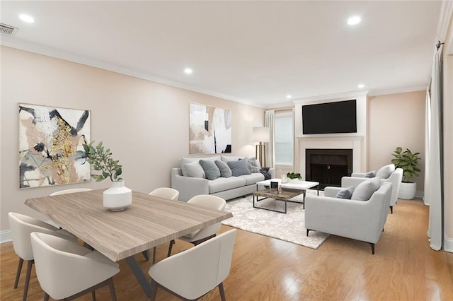 living room featuring light hardwood / wood-style floors and ornamental molding