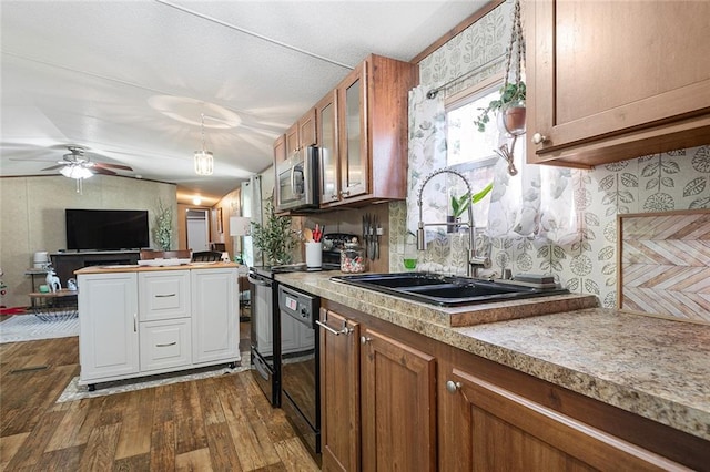 kitchen with dark hardwood / wood-style flooring, ceiling fan, sink, and black dishwasher