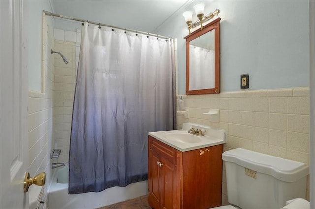 full bathroom featuring vanity, toilet, tile walls, and shower / tub combo