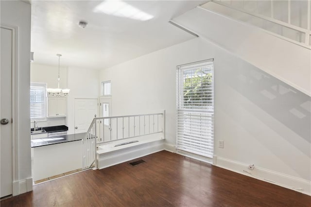 interior space featuring a notable chandelier, dark hardwood / wood-style flooring, and sink