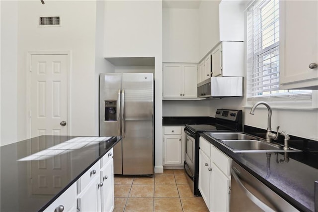 kitchen with light tile patterned flooring, stainless steel appliances, white cabinetry, and sink