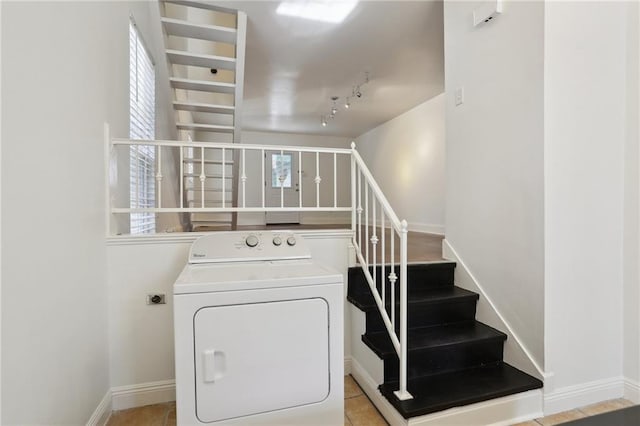 clothes washing area with washer / dryer