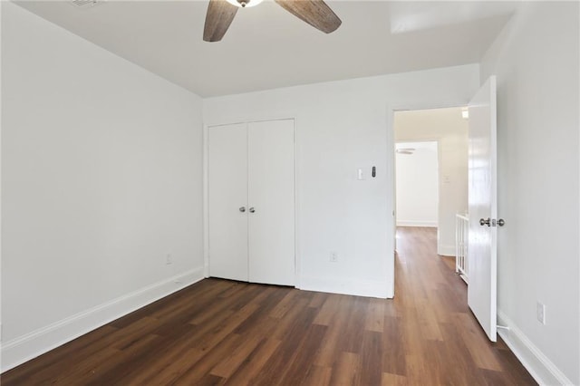 unfurnished bedroom featuring dark hardwood / wood-style flooring, a closet, and ceiling fan