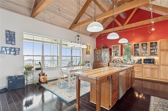 kitchen featuring pendant lighting, high vaulted ceiling, sink, stainless steel dishwasher, and beamed ceiling