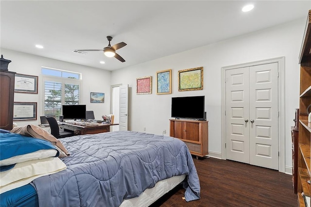 bedroom with dark hardwood / wood-style floors and ceiling fan