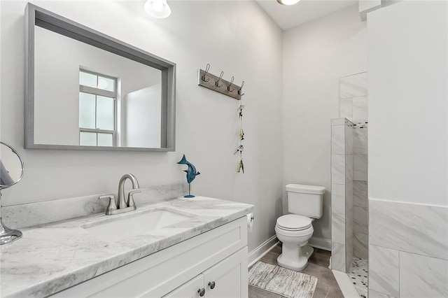 bathroom featuring vanity, toilet, and a shower