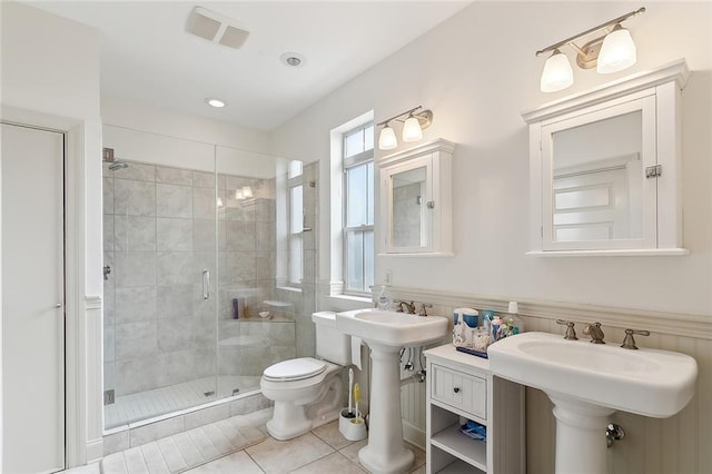 bathroom with tile patterned flooring, toilet, an enclosed shower, and sink