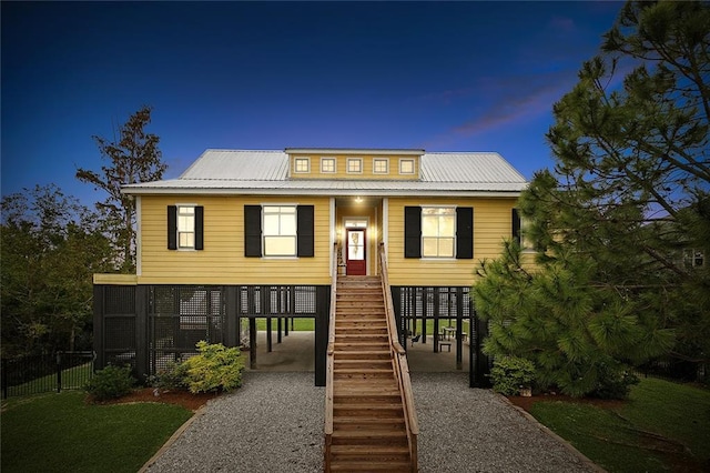 view of front of property featuring a carport and a yard