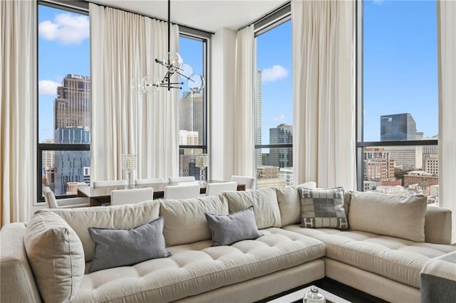 living room with expansive windows and a notable chandelier