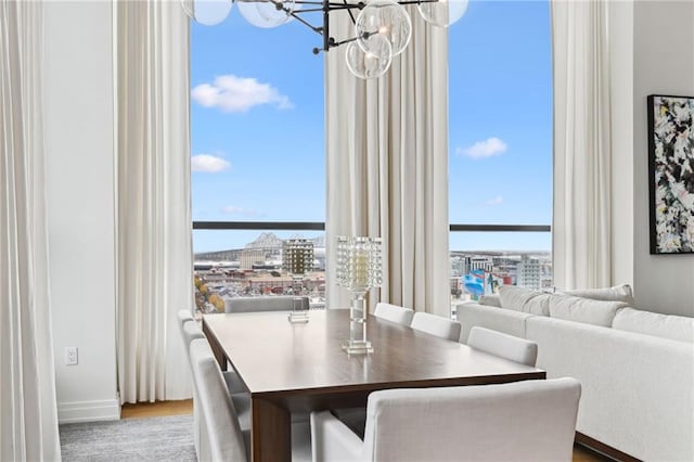 dining area featuring hardwood / wood-style floors, an inviting chandelier, and a wealth of natural light