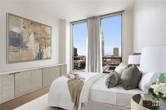 bedroom with light hardwood / wood-style flooring and expansive windows