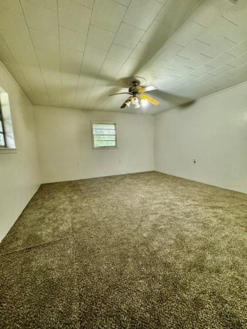 carpeted spare room with ceiling fan