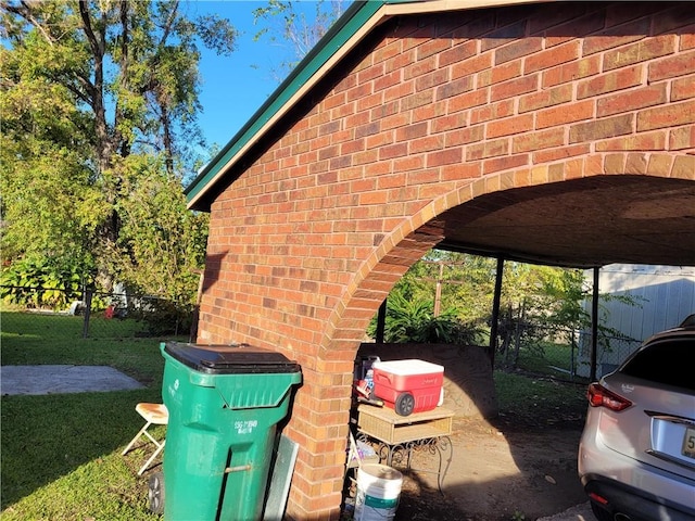 view of side of property featuring a carport and a yard