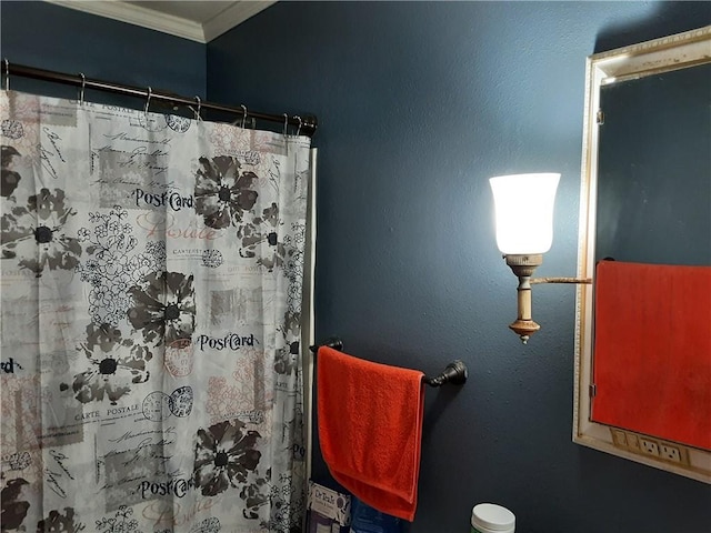 bathroom featuring ornamental molding and curtained shower