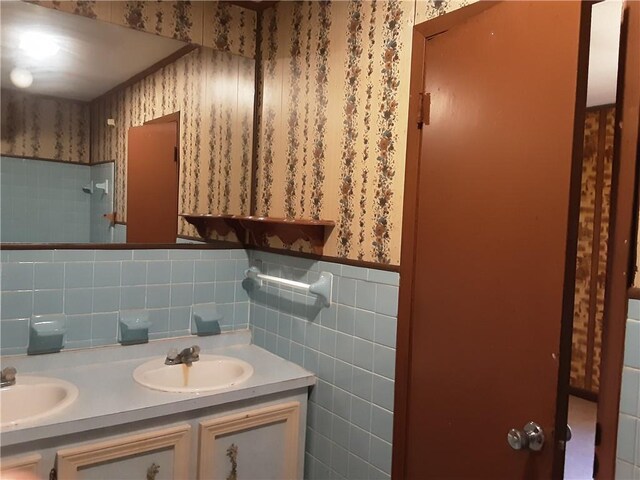 bathroom featuring vanity and tile walls