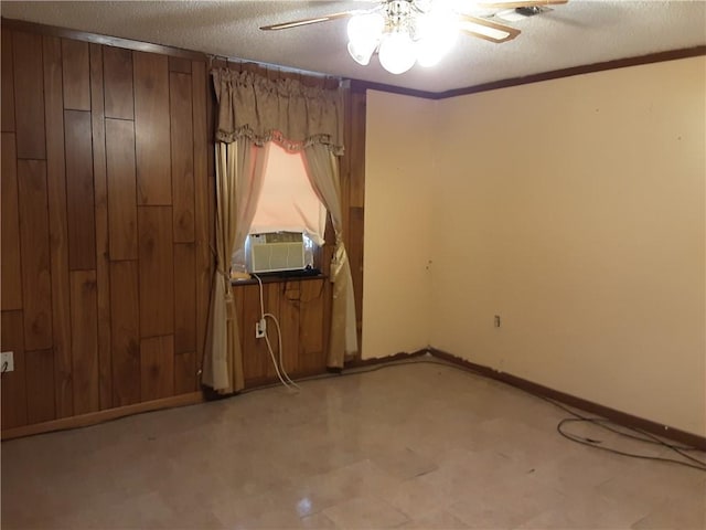 unfurnished room with a textured ceiling, ceiling fan, ornamental molding, and cooling unit