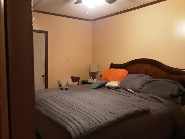 bedroom with ceiling fan and ornamental molding