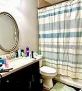 full bathroom featuring vanity, toilet, and shower / bath combo with shower curtain