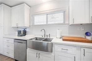 kitchen with white cabinetry, sink, and stainless steel dishwasher