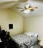 bedroom featuring lofted ceiling and ceiling fan