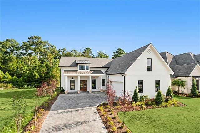 view of front of home with a garage and a front lawn