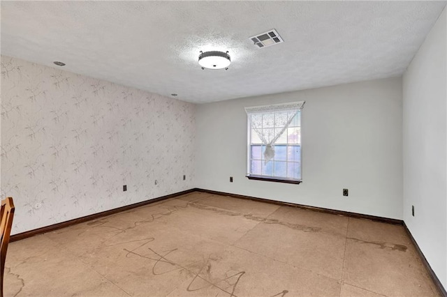 empty room with a textured ceiling