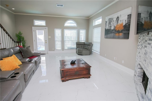 living room featuring crown molding and a fireplace