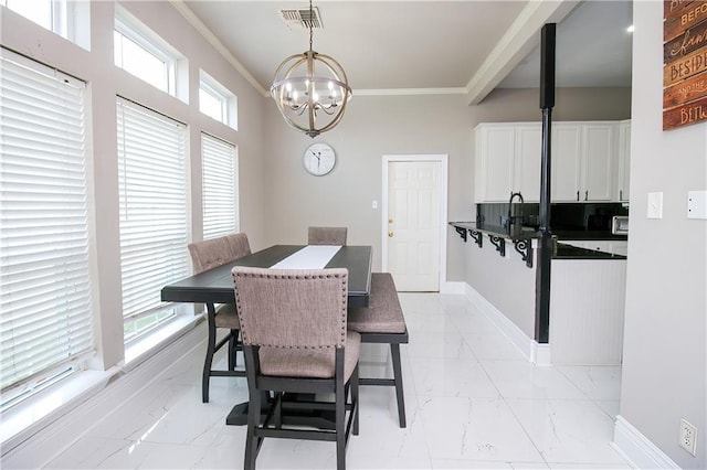 dining room featuring a chandelier and ornamental molding