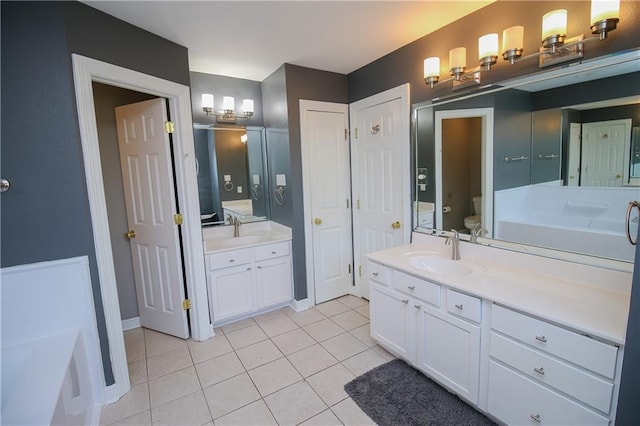 bathroom with tile patterned floors, vanity, and toilet