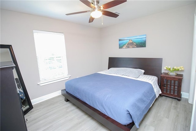 bedroom with ceiling fan and light hardwood / wood-style floors